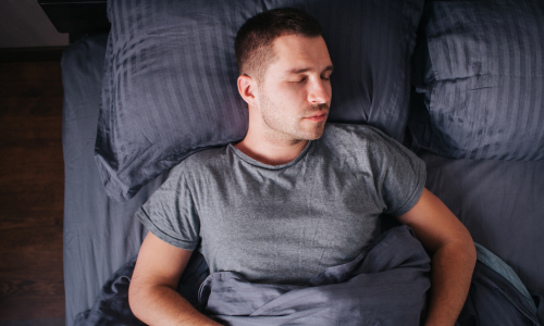 Sleeping Man Man sleeping in bed after taking Shanti for Sleep Supplement